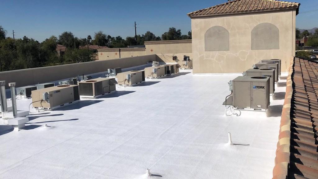 Flat TPO roof with HVAC units on a retail building in Boerne