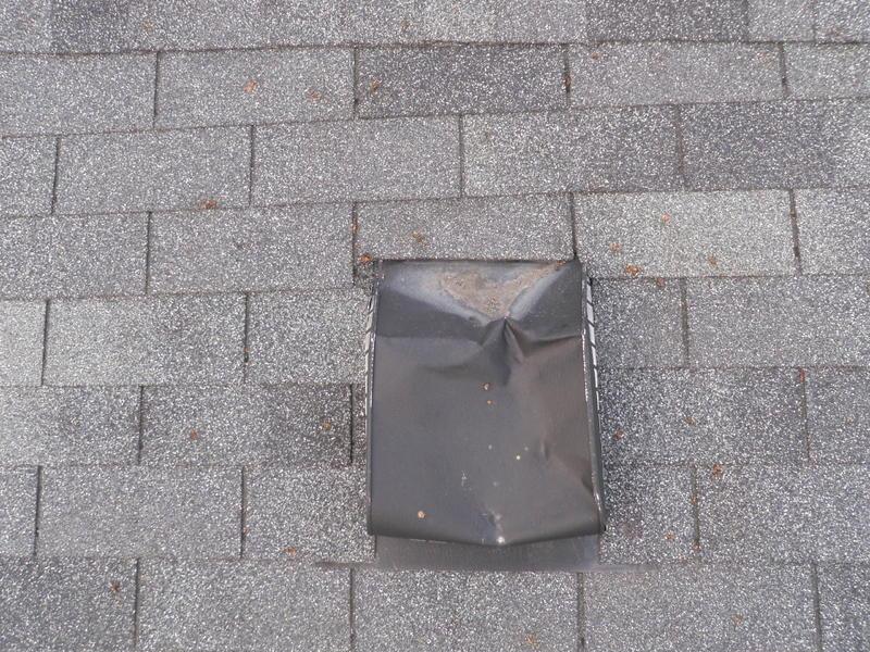 Hail-dented metal roof vent and bruised shingles on a Bulverde home