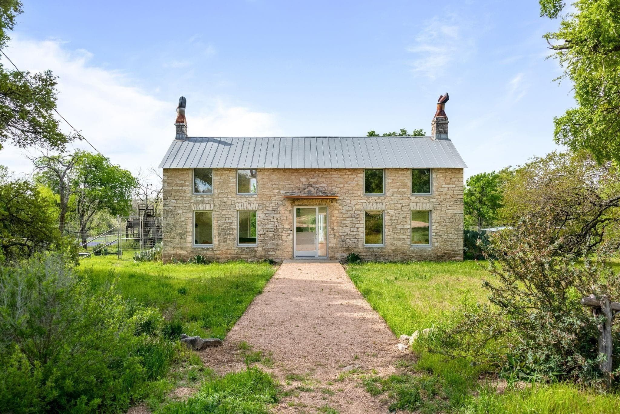 Standing seam metal roof on a historic limestone home in Comfort, Texas