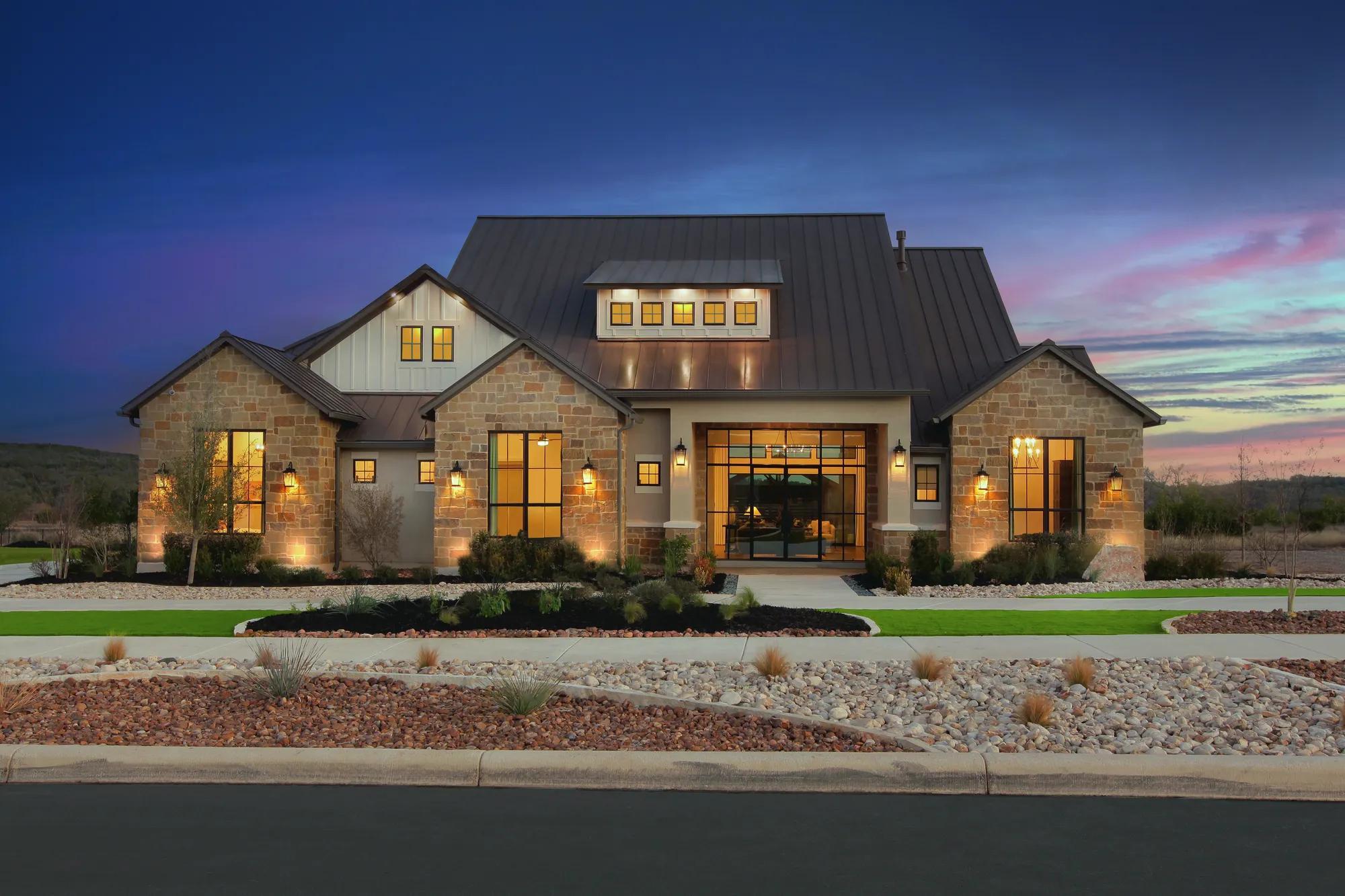 Standing seam metal roof in matte charcoal on a limestone Hill Country home in Boerne