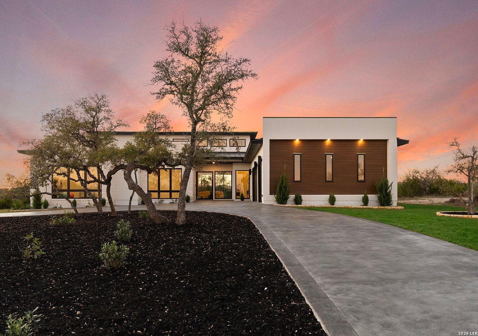 White TPO membrane roof on a modern Hill Country home outside Boerne
