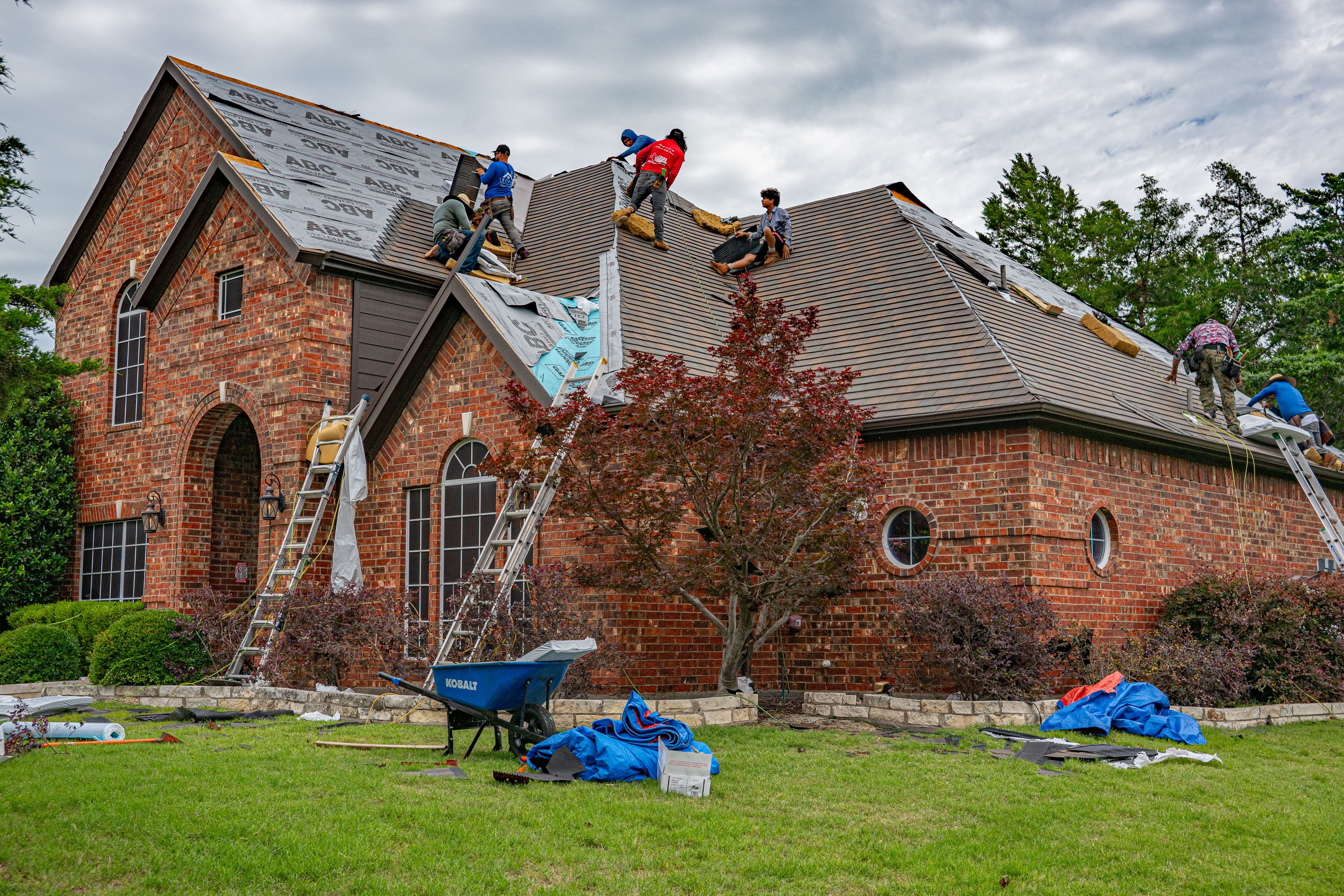 A1 Boerne Roofing crew members on a job site in Boerne with materials staged for installation