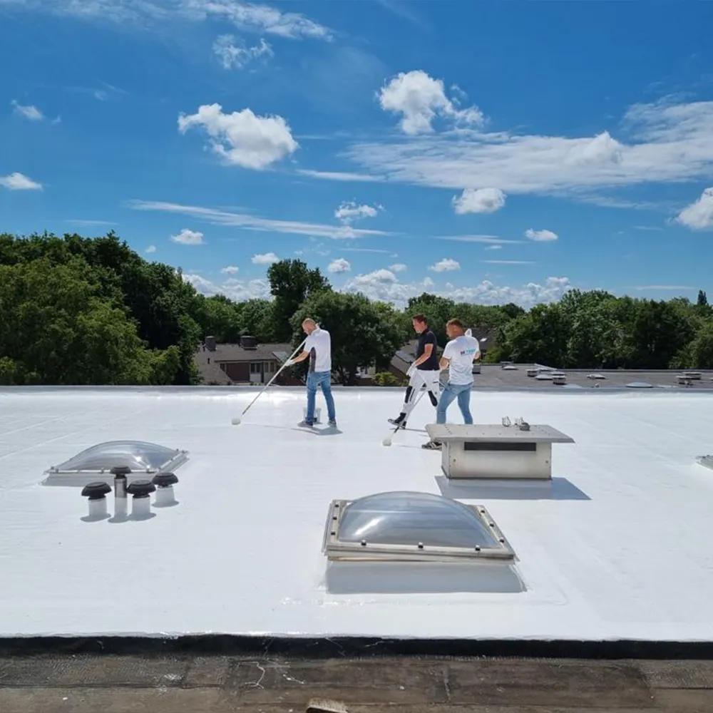 Roofer applying reflective coating to a commercial flat roof in Boerne
