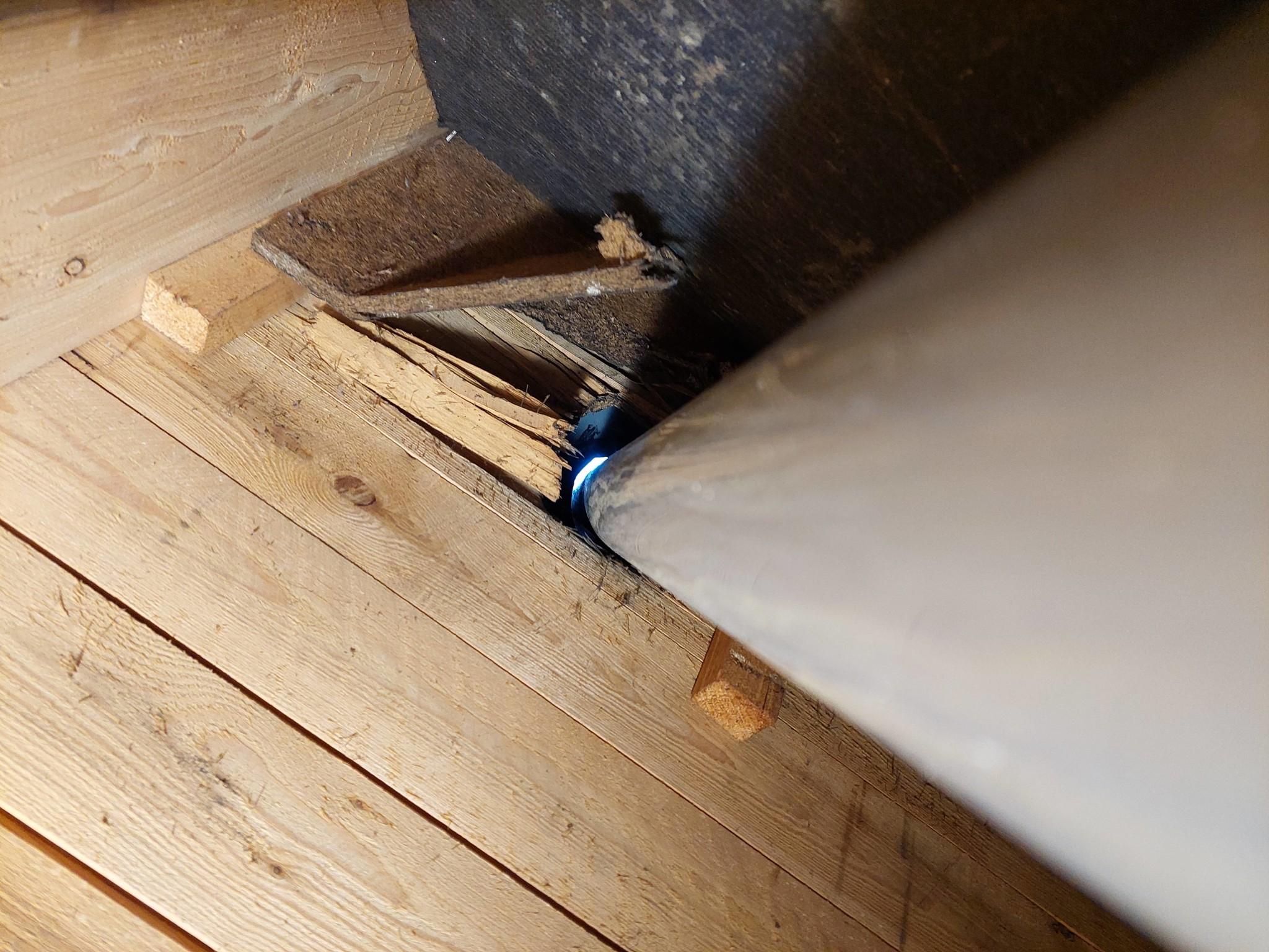 Water stain on decking in an attic tracing back to a cracked pipe boot
